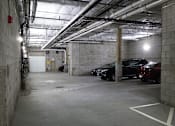 Thumbnail 36 of 36 - Underground parking garage with concrete pillars and vehicles at 68 Beale Apartments, Quincy, Massachusetts